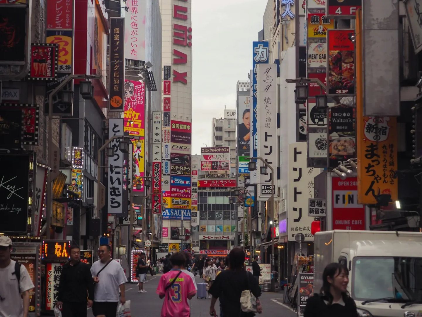 Busy street illuminated by neon signs